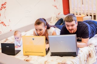 Family of three browsing on laptops