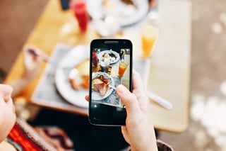 Individual taking a picture of their food