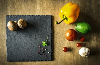 Selection of vegetables and a slate chopping board