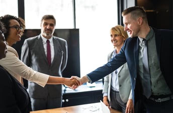 Business owner and investor shaking hands in a meeting